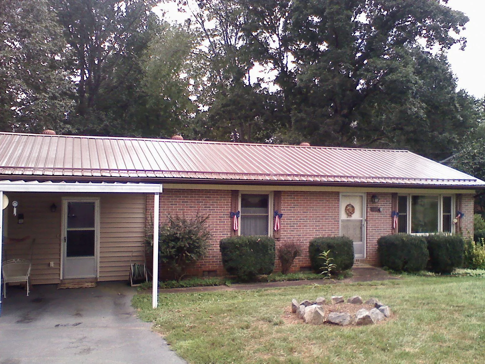 Bronze metal roof and carport on a brick ranch home — Roof Repair work by our crew in New Haven